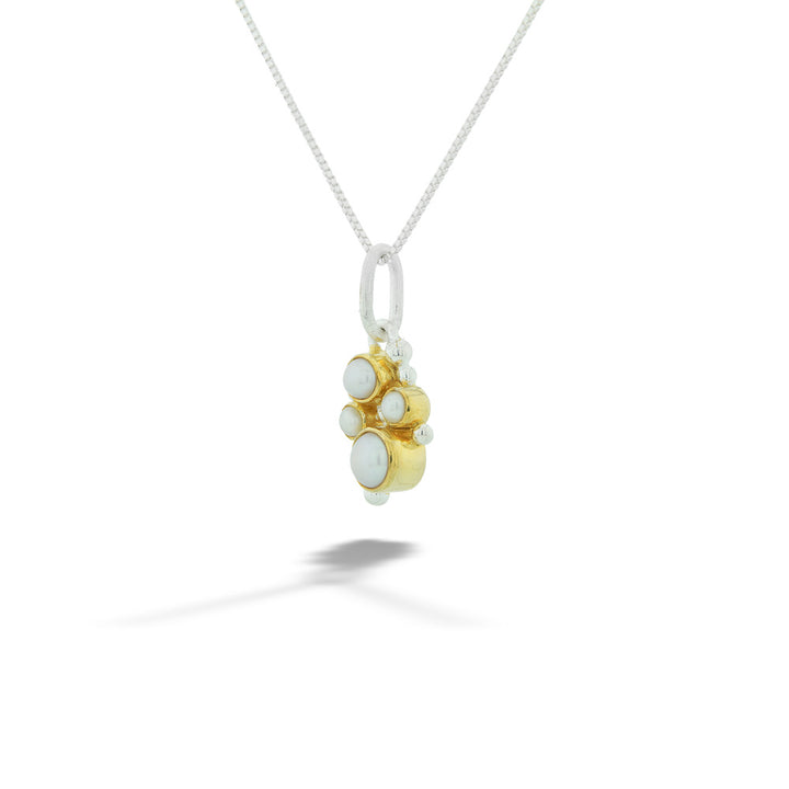Necklace with a gold and silver pendant on a white background  22K Gold Vermeil Pearl Pendant by Michou 