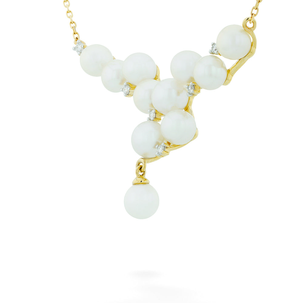 Necklace with white beads and gold accents on a white background Pearl and Diamond "V" Necklace - 16-18"