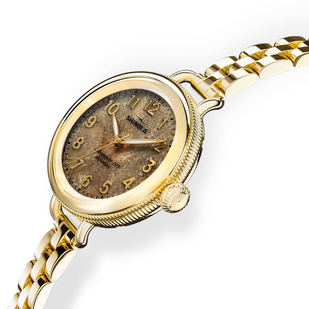 Gold wristwatch with a detailed face on a white background Woman's Birdy Watch by Shinola