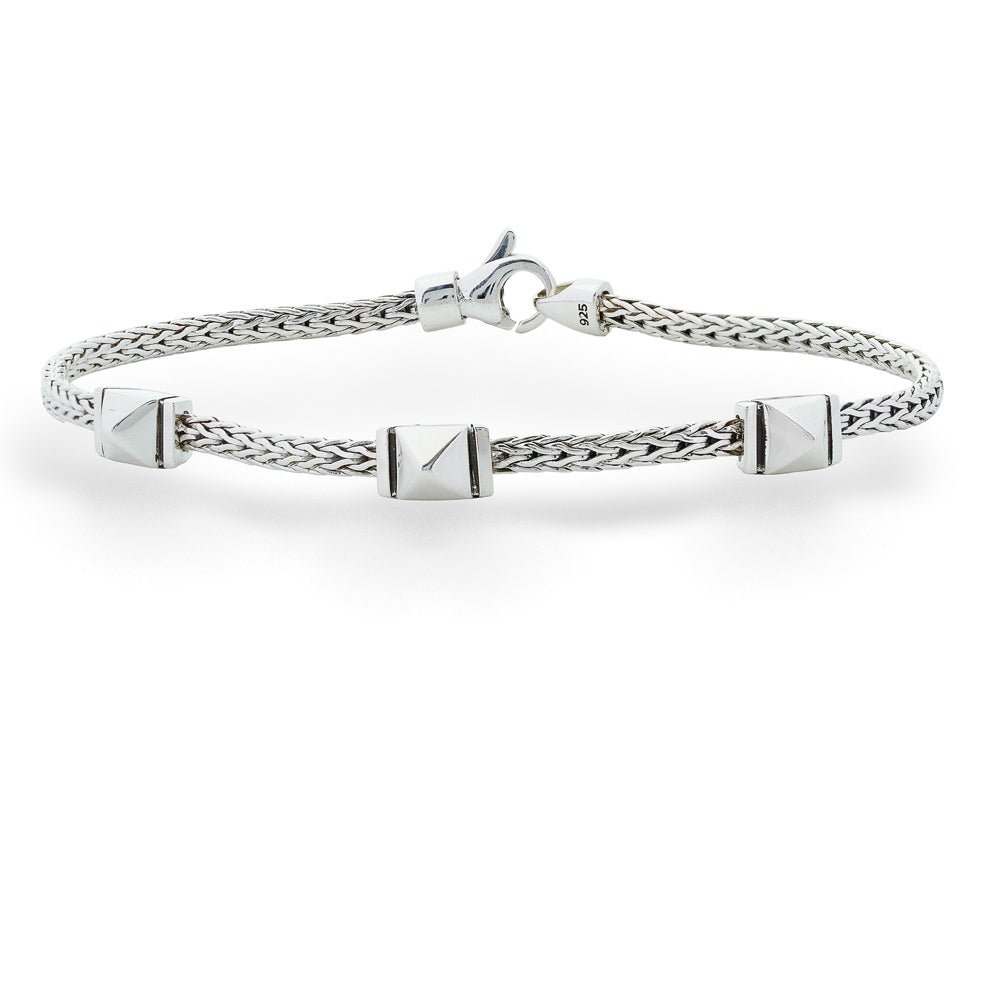 Silver bracelet with pyramid-shaped charms on a white background Icon Silver 3 Station Stud Thin Bracelet by John Hardy 