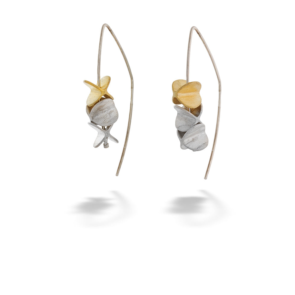 Pair of earrings with shell-like designs on a white background Two-Tone Spinning Oval Threader Earrings by Mysterium