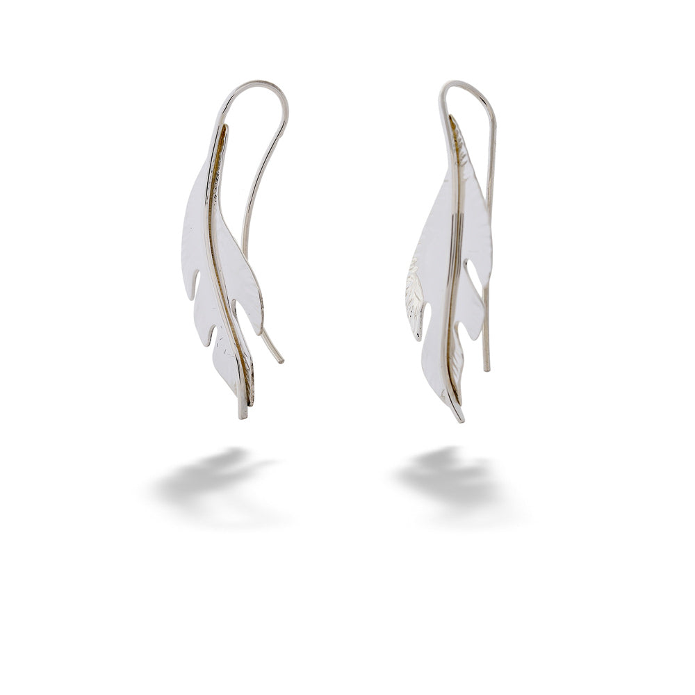 Pair of silver feather-shaped earrings on a white background “Folio” Earrings by E.L. Designs