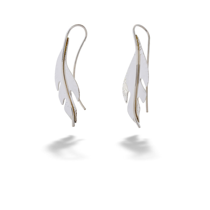 Pair of silver feather-shaped earrings on a white background “Folio” Earrings by E.L. Designs