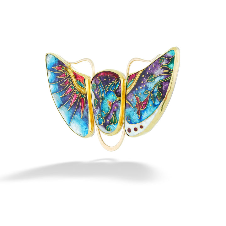 Colorful butterfly-shaped pendant with gold accents on a white background Hummingbird Enamel Enhancer by Katrin Wolf