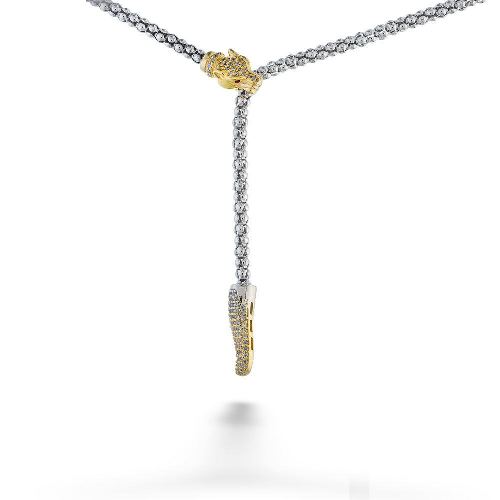 Necklace with gold and silver pendants on a white background Lioness Lariat Necklace by Miss Mimi 