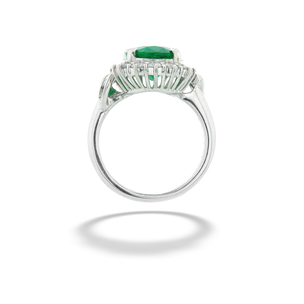 Silver ring with green gemstone on a white background Zambian Emerald Halo Ring