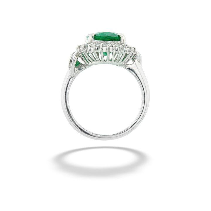 Silver ring with green gemstone on a white background Zambian Emerald Halo Ring