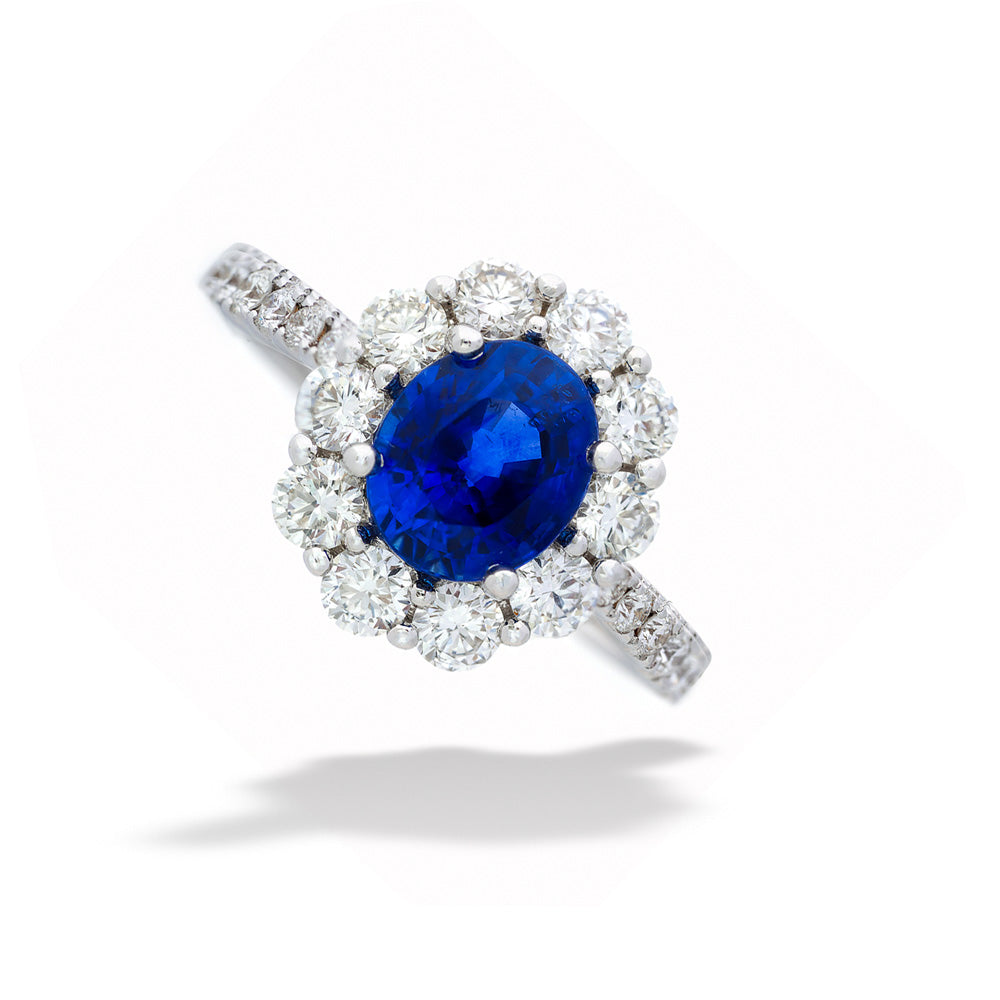 Diamond ring with a blue gemstone on a white background Blue Sapphire Halo Ring