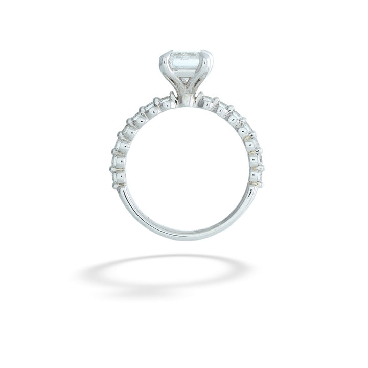 Diamond ring with a central gemstone and smaller stones on a white background Emerald-Cut Lab Grown Diamond Ring