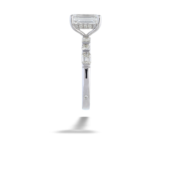 Diamond ring with a unique design on a white background Emerald-cut Diamond Engagement Ring with Diamond Band by Valina