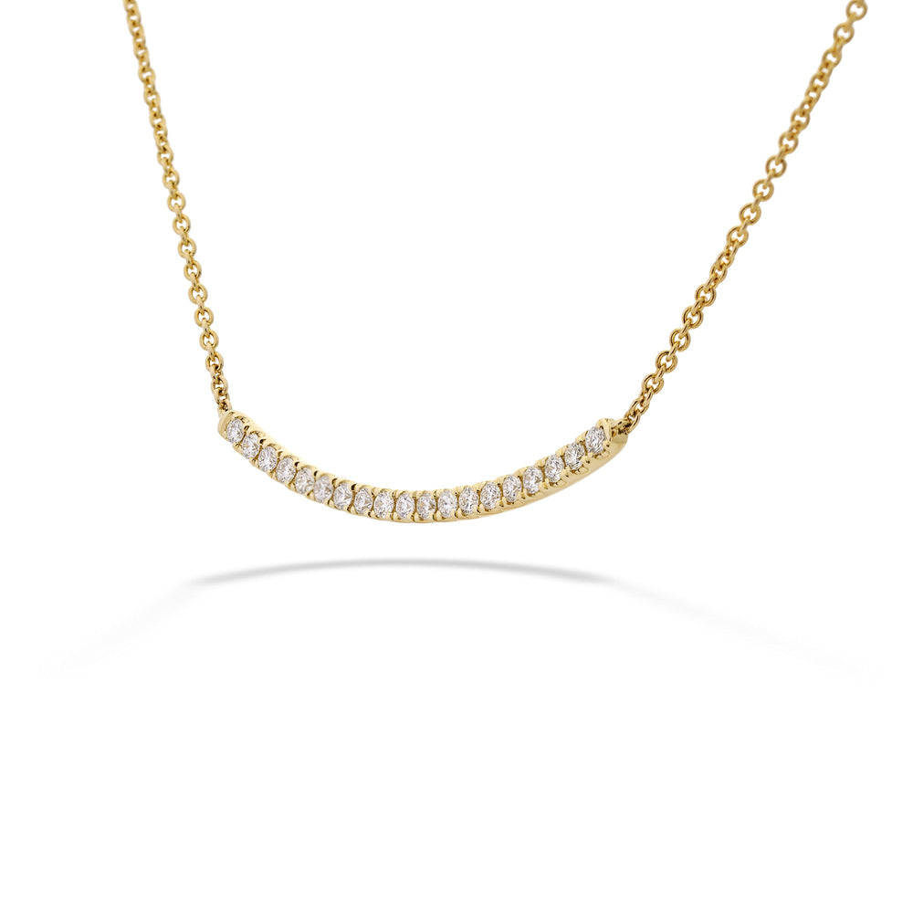 Gold necklace with small diamonds on a white background 14K Gold Diamond Curved Bar Necklace