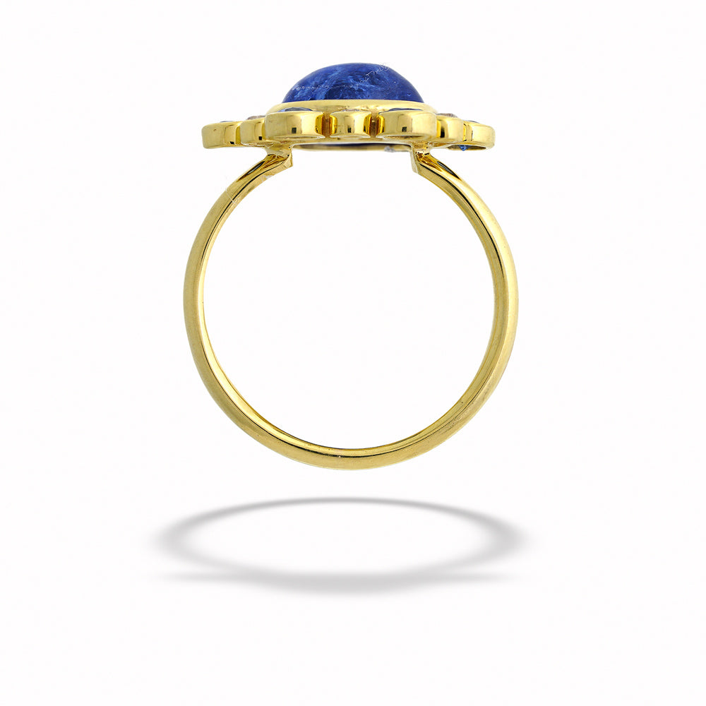 Gold ring with a blue gemstone on a white background Tanzanite, Sapphire, and Diamond Ring by Mazza