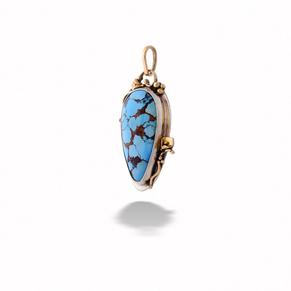 Turquoise pendant with gold setting on a white background Turquoise Pendant with Gold Peace Lilies