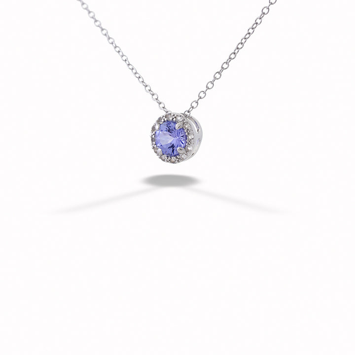 Necklace with a purple gemstone pendant on a white background Tanzanite Halo Pendant Necklace by Samuel B. 