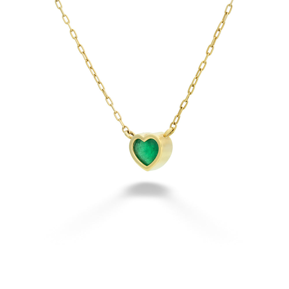 Gold necklace with a green heart-shaped pendant on a white background  Emerald Heart Necklace by Lauren K. 