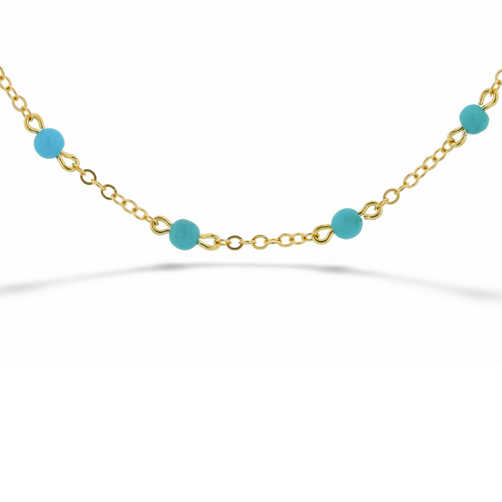 Gold bracelet with blue beads on a white background  14K Yellow Gold Chain and Turquoise Bead Bracelet 