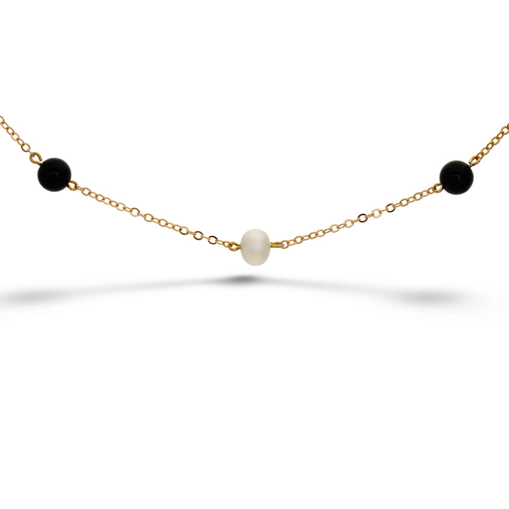 Gold necklace with black and white beads on a white background Pearl and Onyx Bracelet - 7"