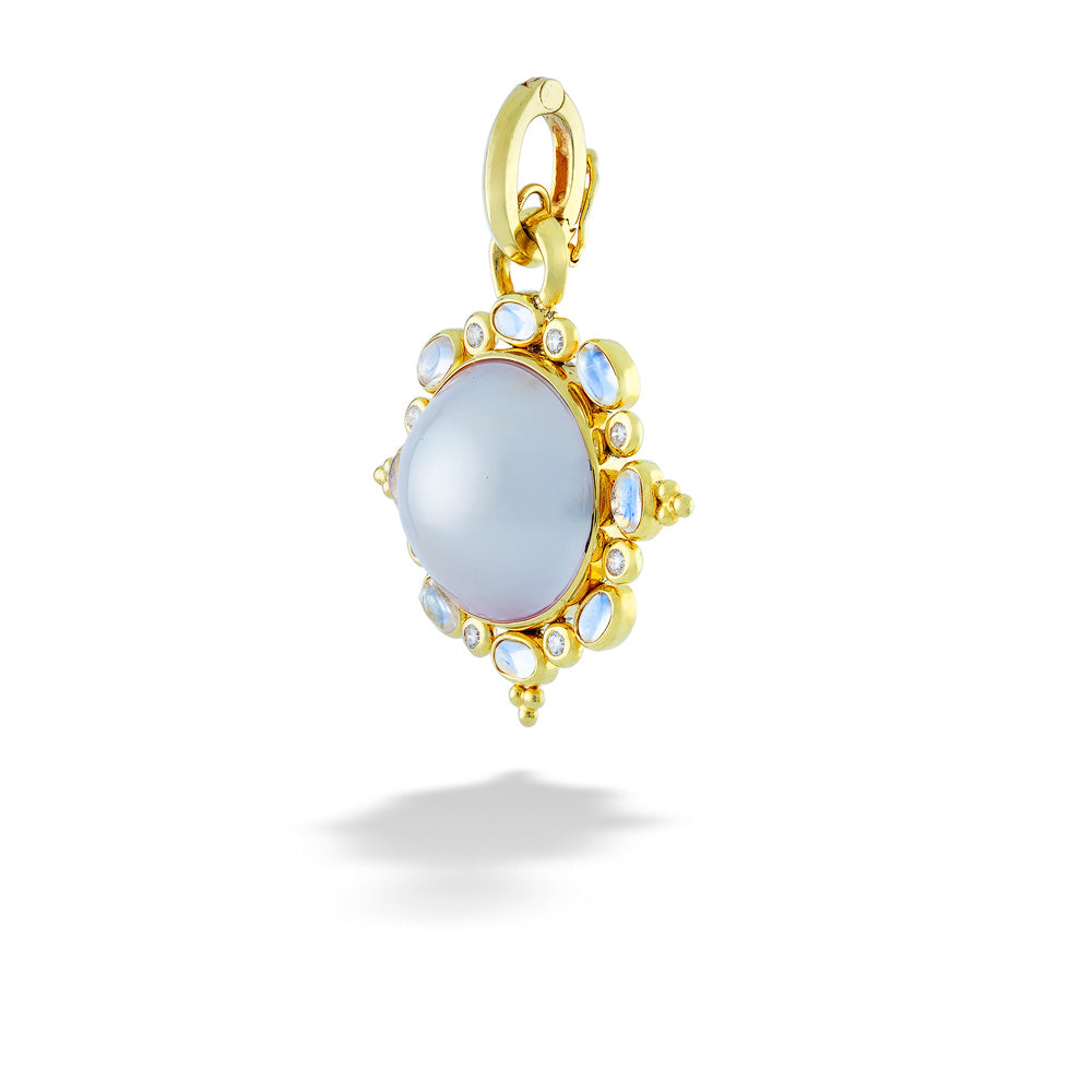 Gold pendant with a central blue stone and smaller stones around on a white background Mobe Pearl with Moonstone and Diamond Halo Pendant by Mazza