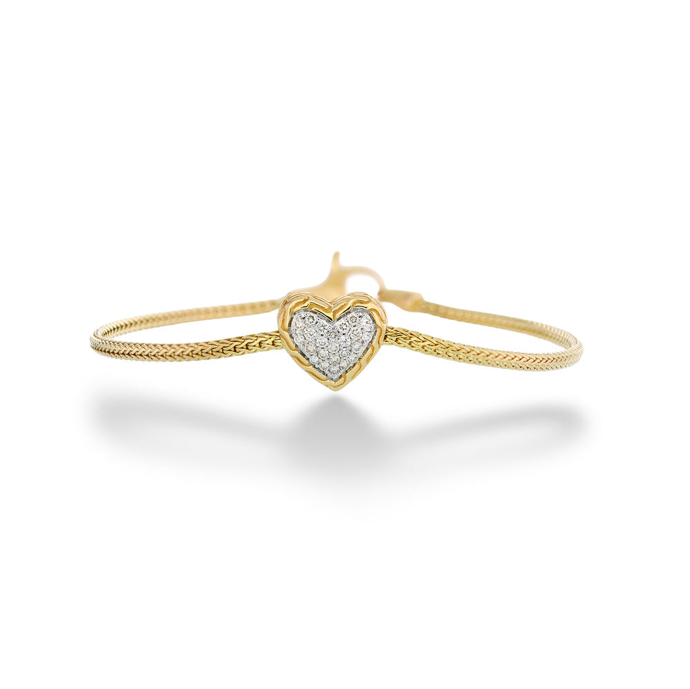 Gold bracelet with a heart-shaped diamond pendant on a white Essentials Heart Bracelet by John Hardy background