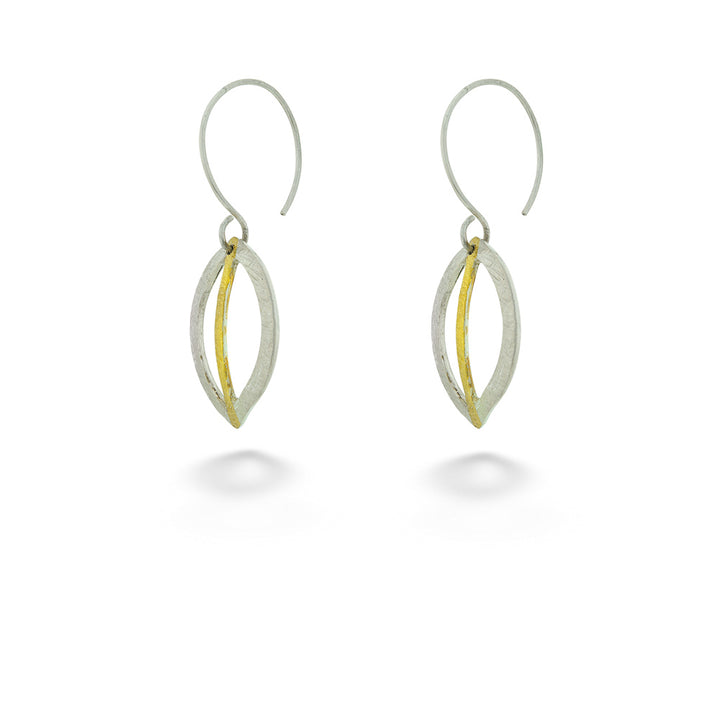 Pair of silver and gold earrings on a white background Hollow Leaf Earrings by Melanie Considine