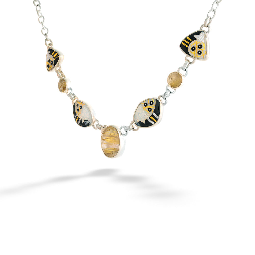 Necklace with bee-shaped beads on a white background White, Black, and Gold Enameled Necklace by Ricky Frank
