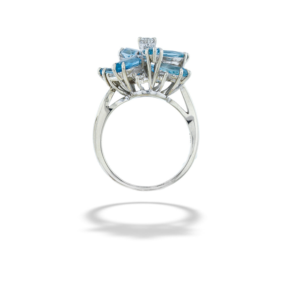 Silver ring with blue gemstones on a white background Aquamarine and Diamond Cluster Ring