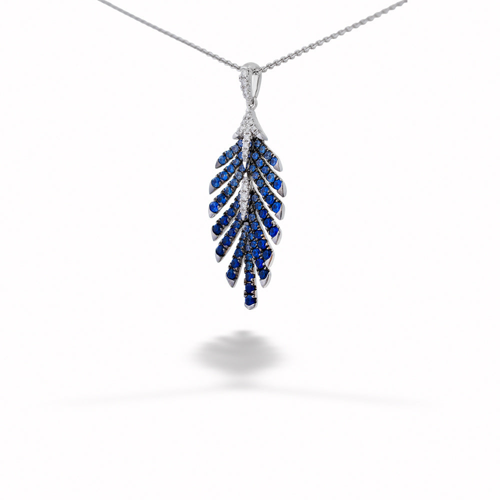 Silver necklace with a blue gemstone pendant on a white background Sapphire and Diamond Leaf Pendant Necklace 