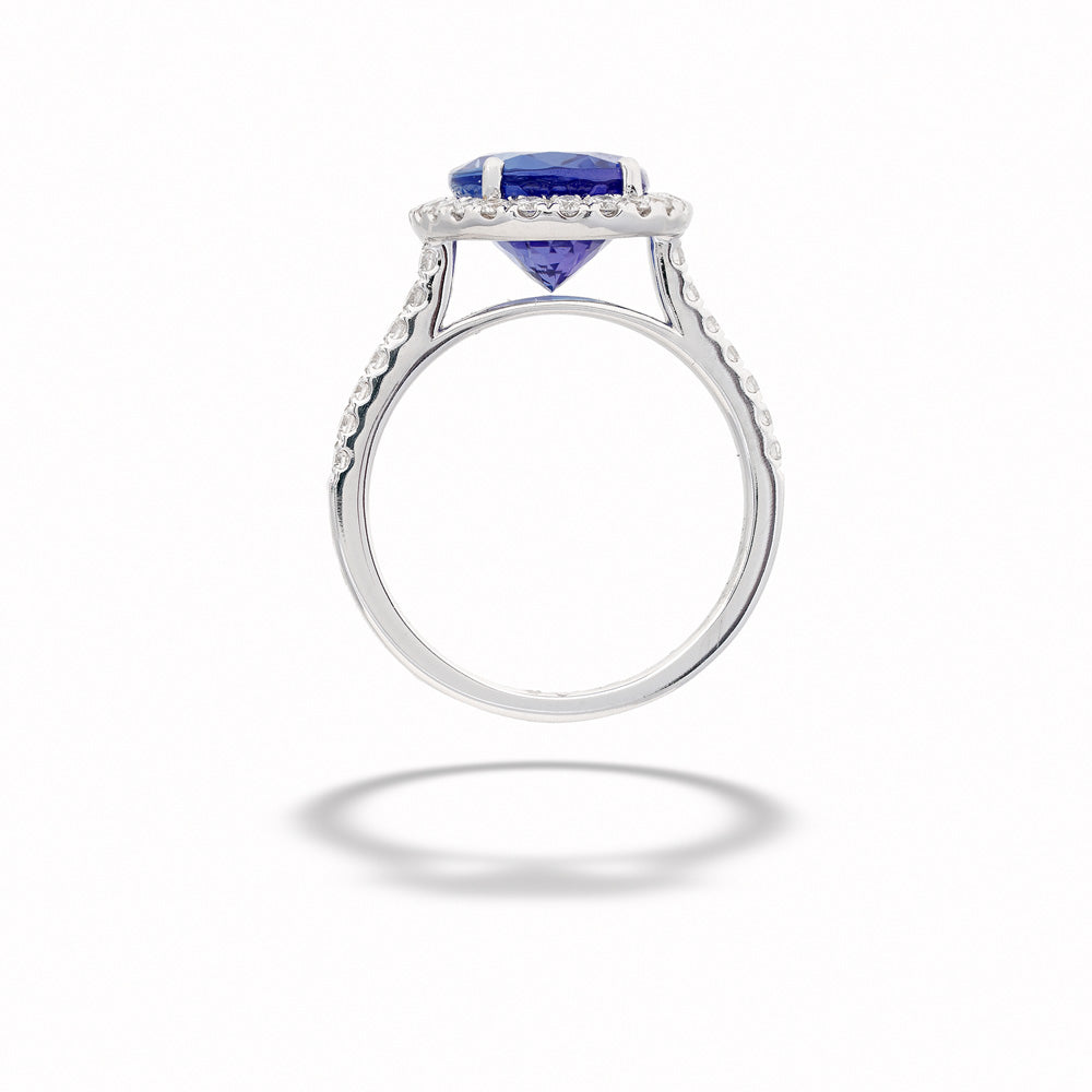 Silver ring with a blue gemstone on a white background Oval Tanzanite and Diamond Ring