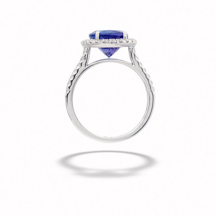 Silver ring with a blue gemstone on a white background Oval Tanzanite and Diamond Ring