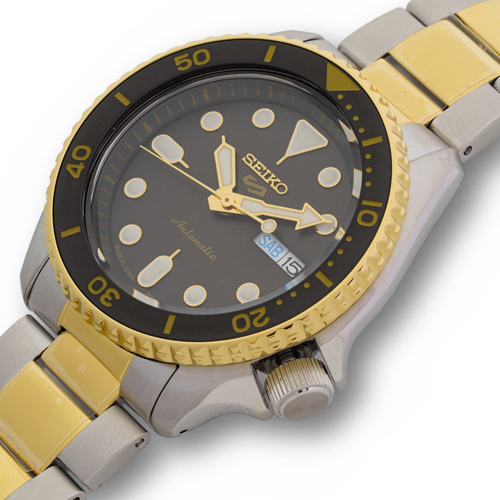 Seiko watch with gold and silver band on a white background Two-Tone 42.5mm Charcoal Dial 5 Sports Automatic Watch by Seiko